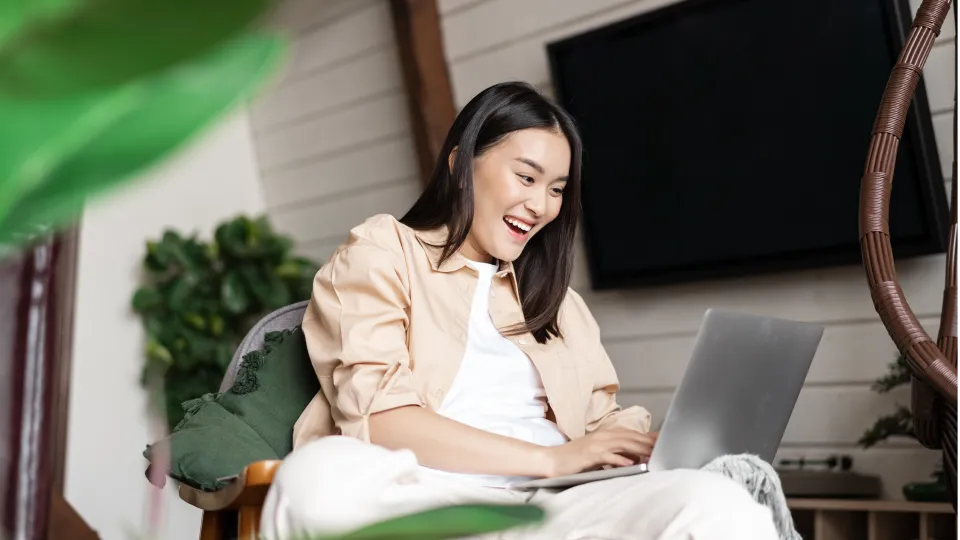 Student celebrating receiving good news on laptop
