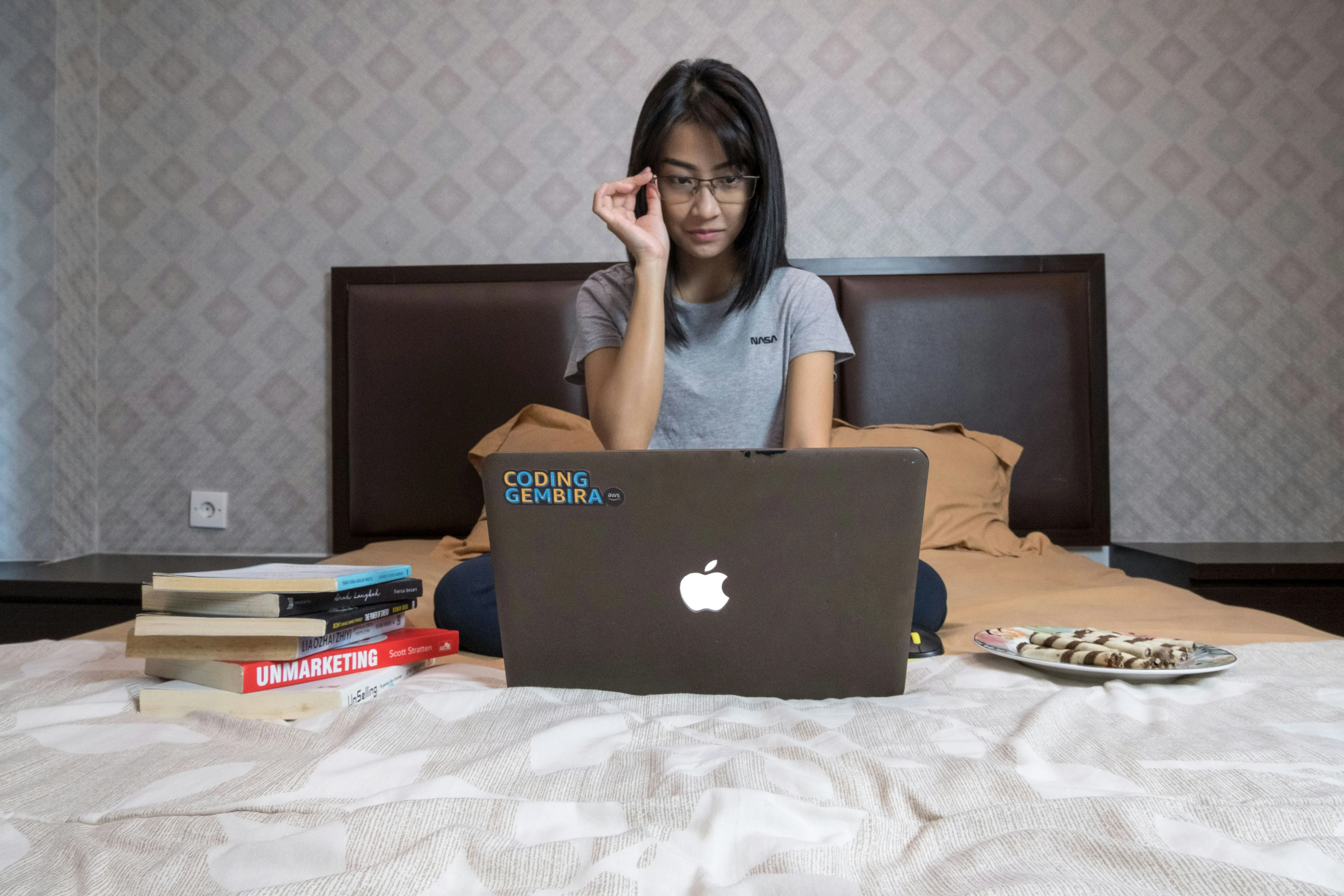 Student learning online with laptop and course materials